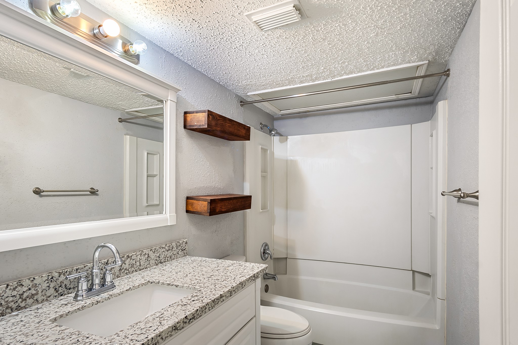 7402 Alabonson Road, Unit 510 Houston, TX 77088 - Photo 11 of 14 a bathroom with a granite countertop bathtub shower sink vanity and toilet