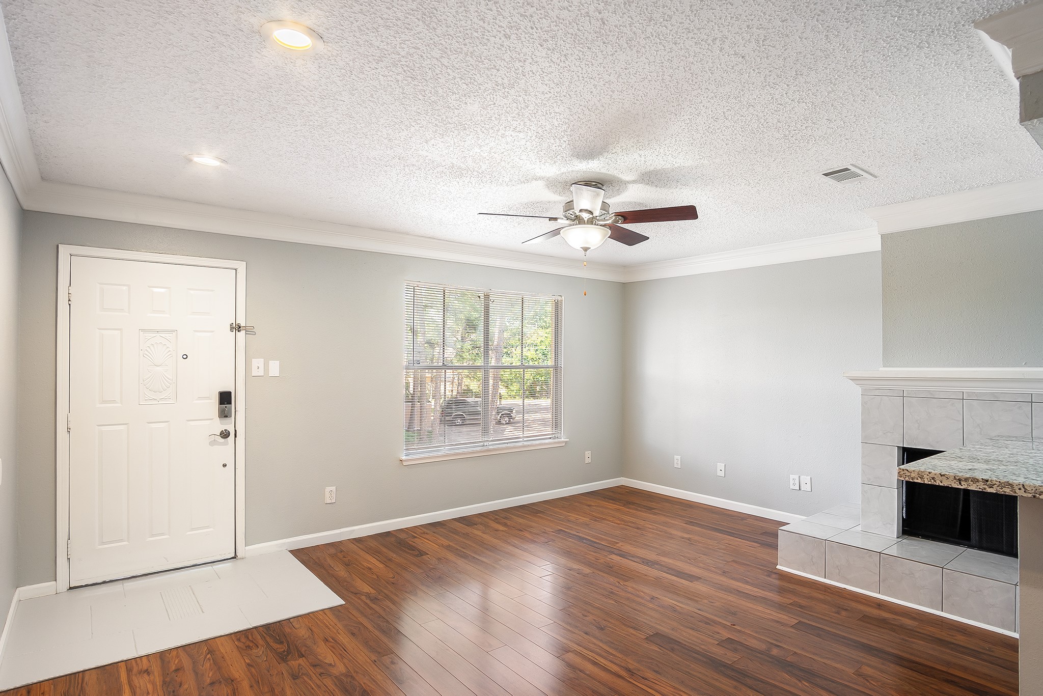 7402 Alabonson Road, Unit 510 Houston, TX 77088 - Photo 3 of 14 an empty room with wooden floor chandelier and windows