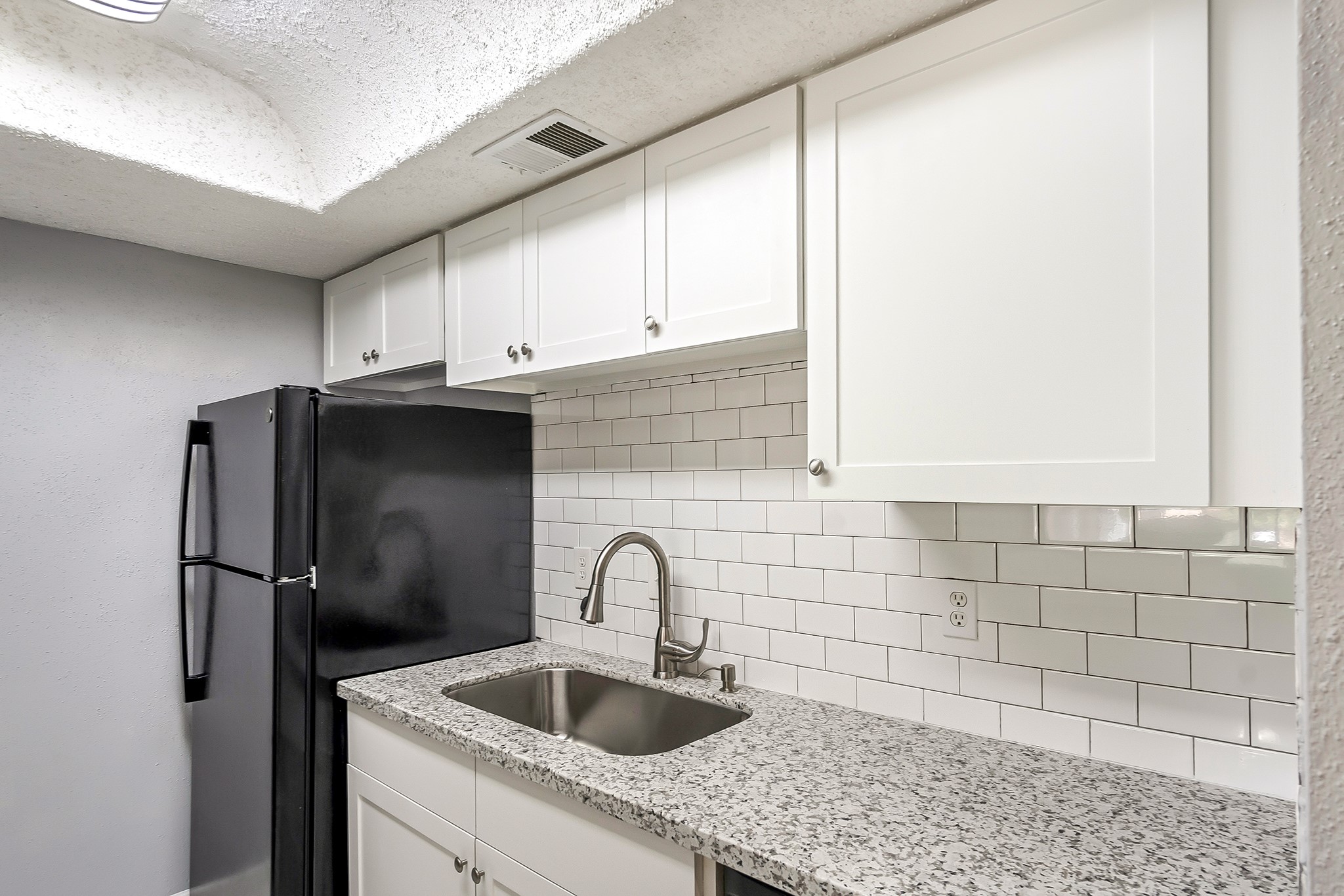 7402 Alabonson Road, Unit 510 Houston, TX 77088 - Photo 10 of 14 a kitchen with stainless steel appliances granite countertop a sink and a refrigerator
