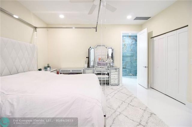 a bed room with a bed and a chair