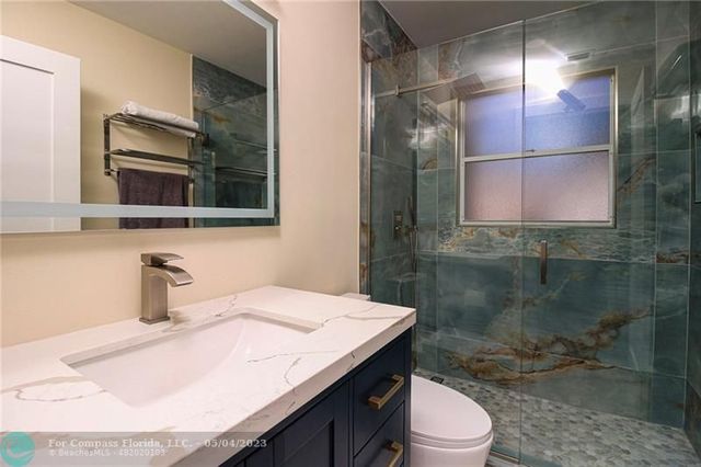 a bedroom with a bed a table and a window