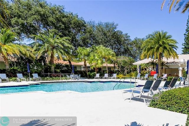 a front view of a house with a garden and a yard