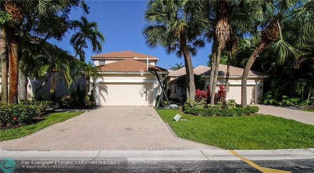 a view of a backyard with potted plants and large trees