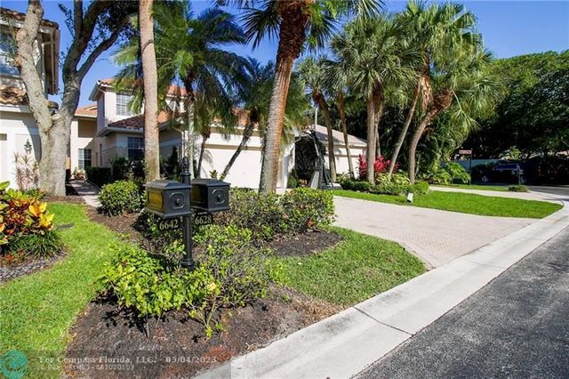 an aerial view of residential houses with outdoor space and street view