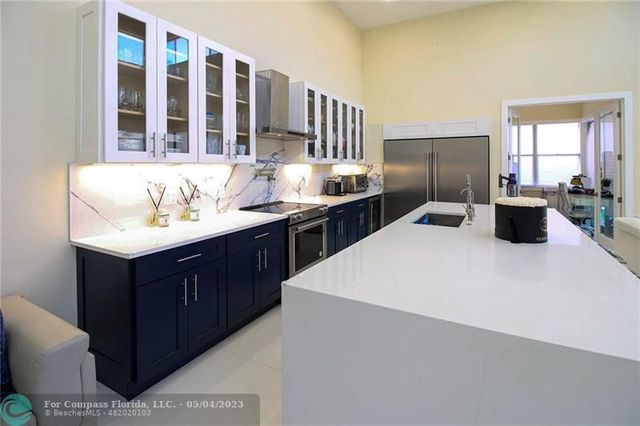 a kitchen with a sink appliances and cabinets