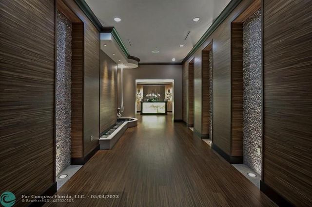 a view of a living room and hall with furniture