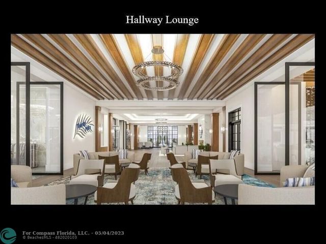 a living room with furniture and large windows