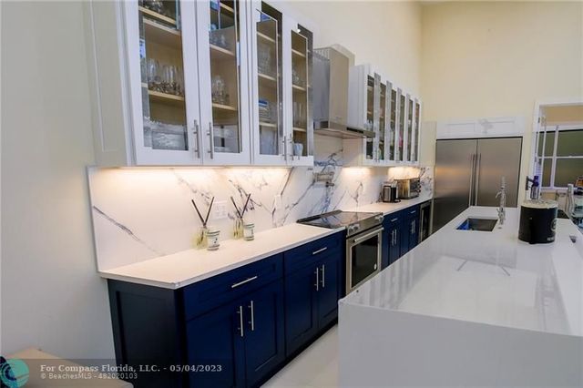 a kitchen with a sink and a refrigerator