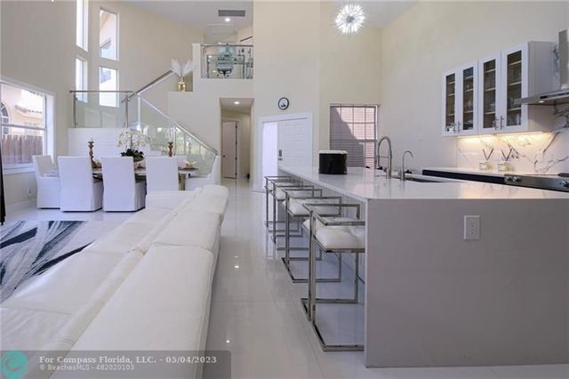 a living room with furniture a flat screen tv and a table