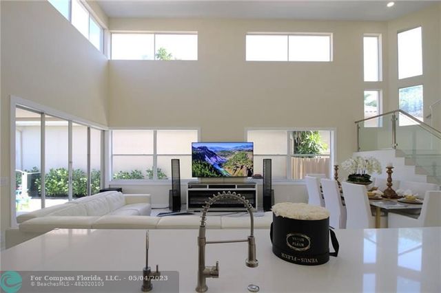 a living room with furniture and a floor to ceiling window