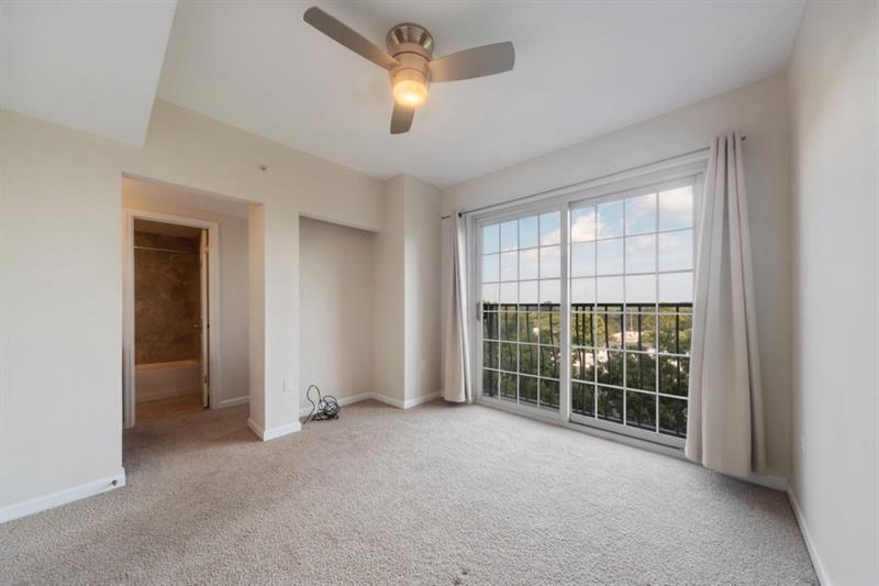 199 14th Street Northeast, Unit 705 Atlanta, GA 30309 - Photo 16 of 20 a view of a livingroom with a ceiling fan and window