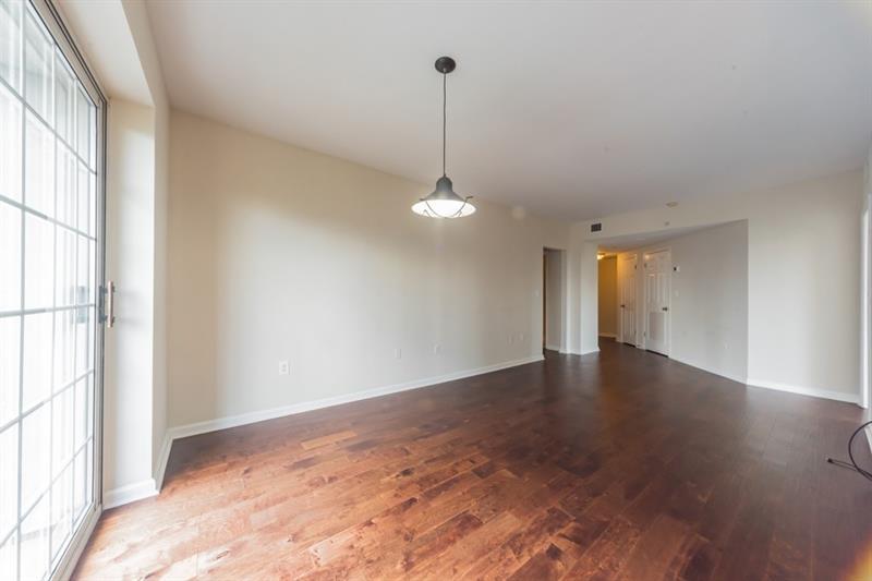 199 14th Street Northeast, Unit 705 Atlanta, GA 30309 - Photo 4 of 20 a view of empty room with wooden floor and fan