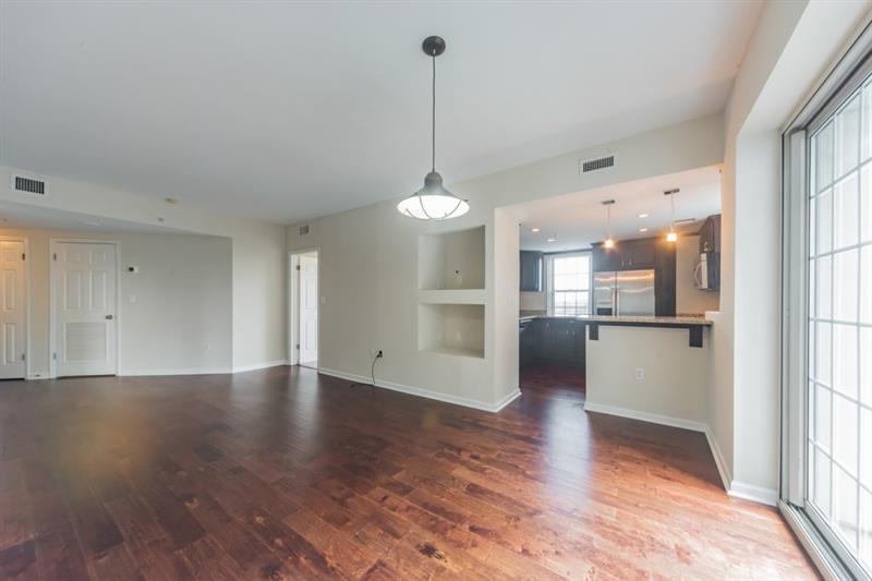 199 14th Street Northeast, Unit 705 Atlanta, GA 30309 - Photo 5 of 20 a view of a kitchen with wooden floor and a sink