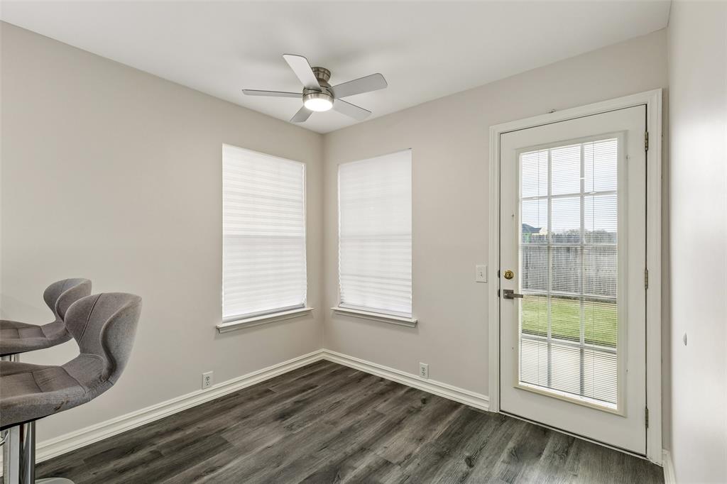 133 Hanover Street Grand Prairie, TX 75052 - Photo 14 of 31 a view of an empty room with a window and wooden floor