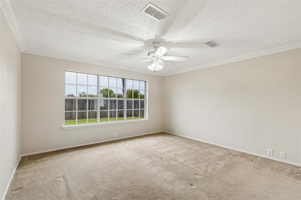 133 Hanover Street Grand Prairie, TX 75052 - Photo 17 of 31 an empty room with windows and ceiling fan