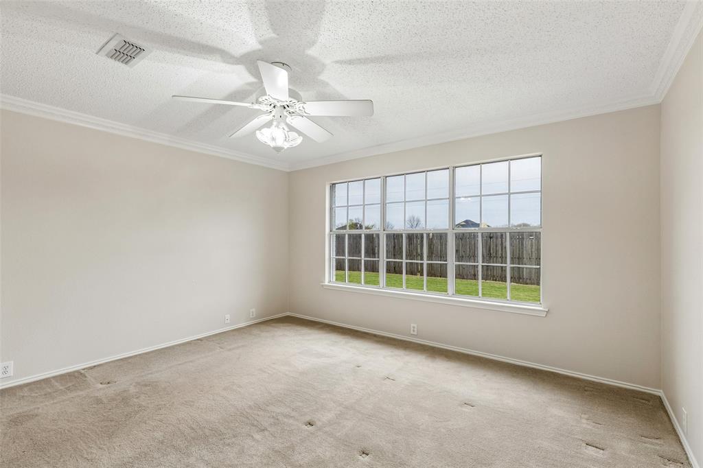 133 Hanover Street Grand Prairie, TX 75052 - Photo 18 of 31 an empty room with windows and ceiling fan
