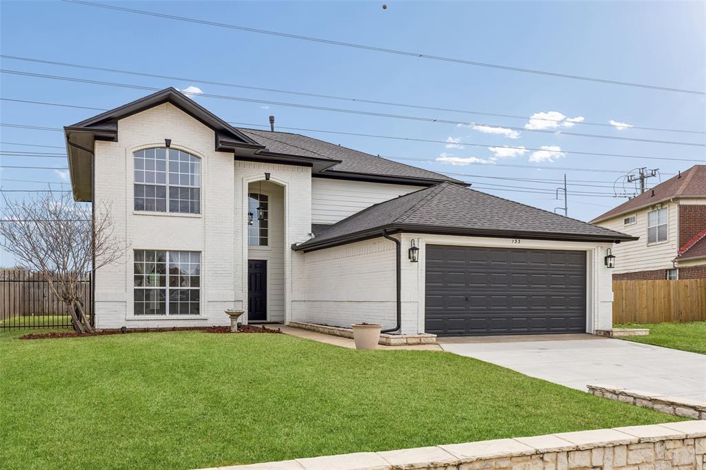133 Hanover Street Grand Prairie, TX 75052 - Photo 2 of 31 a front view of a house with a yard