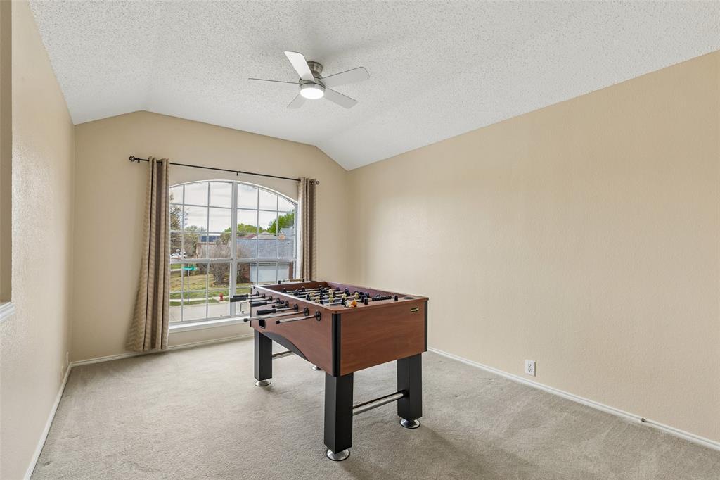 133 Hanover Street Grand Prairie, TX 75052 - Photo 23 of 31 a living room with a table and a window