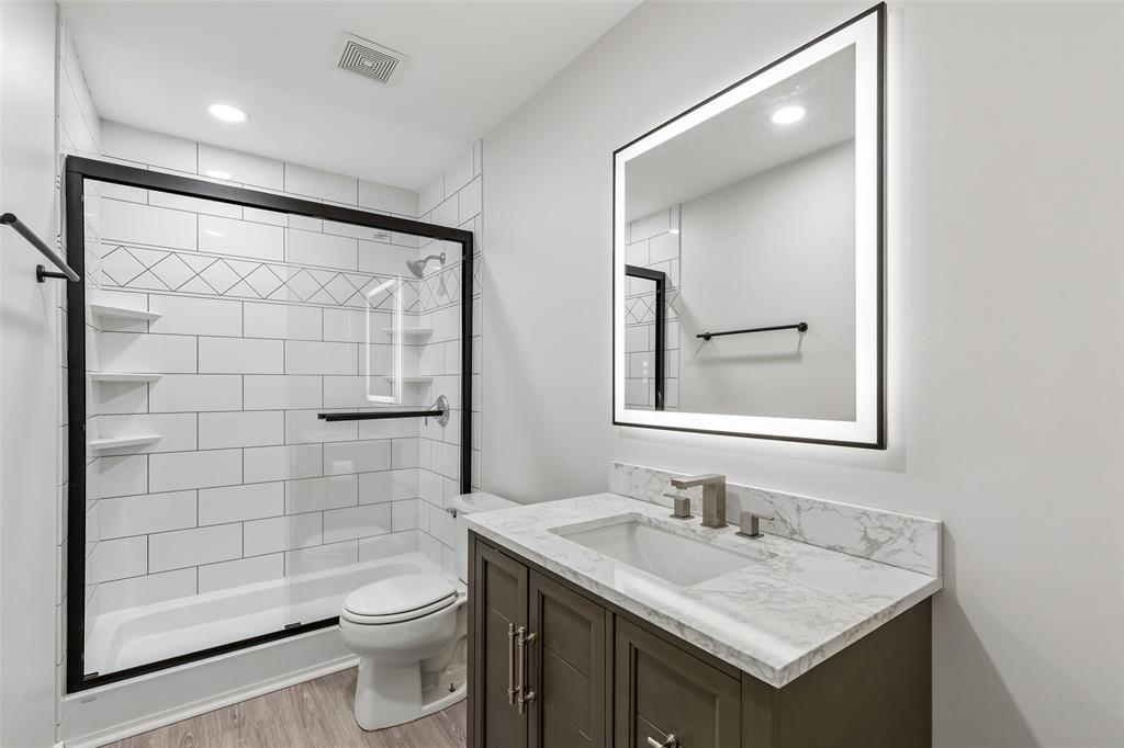 133 Hanover Street Grand Prairie, TX 75052 - Photo 25 of 31 a bathroom with a sink a toilet and shower