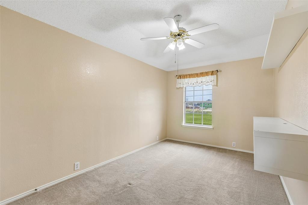 133 Hanover Street Grand Prairie, TX 75052 - Photo 27 of 31 an empty room with a window and a fan