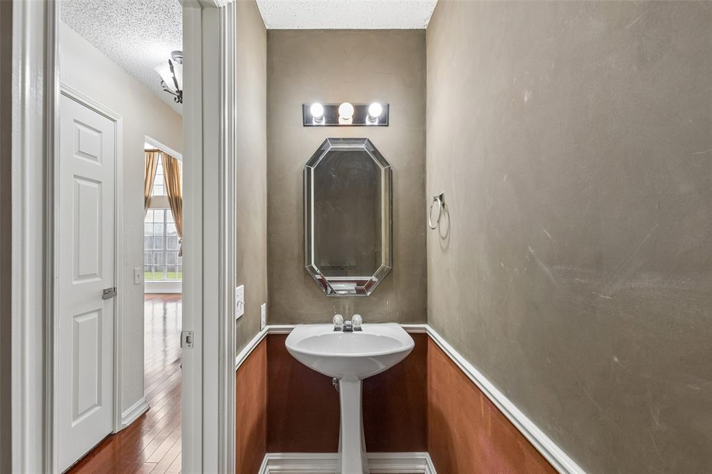 133 Hanover Street Grand Prairie, TX 75052 - Photo 28 of 31 a bathroom with a sink and a mirror