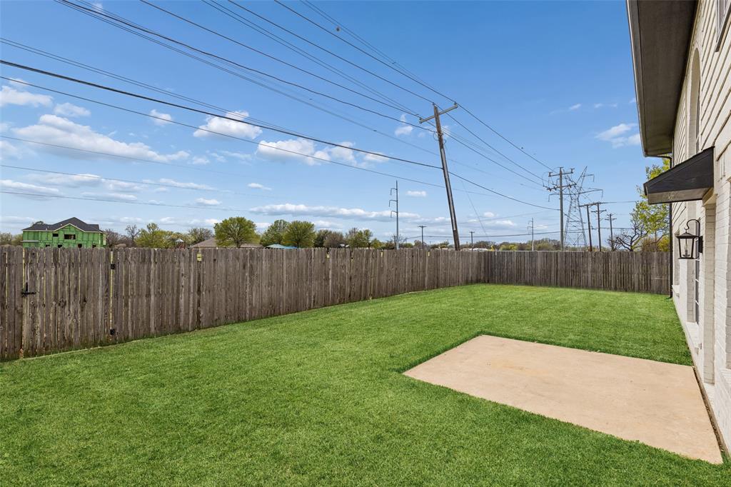 133 Hanover Street Grand Prairie, TX 75052 - Photo 30 of 31 a view of a backyard with wooden fence