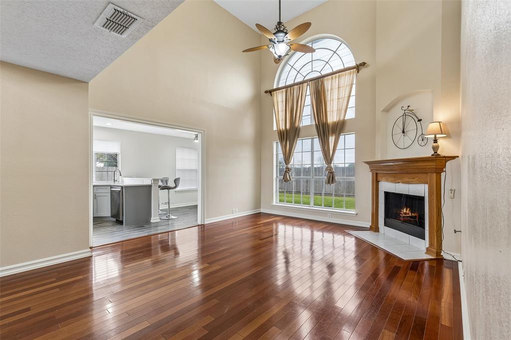 133 Hanover Street Grand Prairie, TX 75052 - Photo 4 of 31 a view of a livingroom with wooden floor fireplace and windows