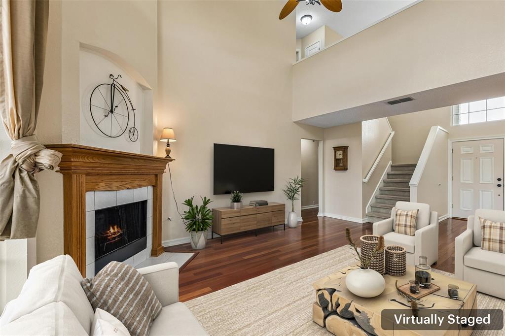 133 Hanover Street Grand Prairie, TX 75052 - Photo 6 of 31 a living room with furniture a fireplace and a flat screen tv