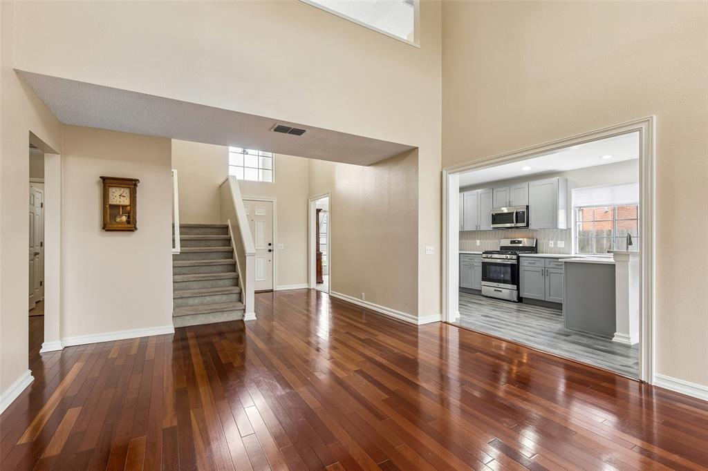 133 Hanover Street Grand Prairie, TX 75052 - Photo 8 of 31 a view of a kitchen with wooden floor and a kitchen