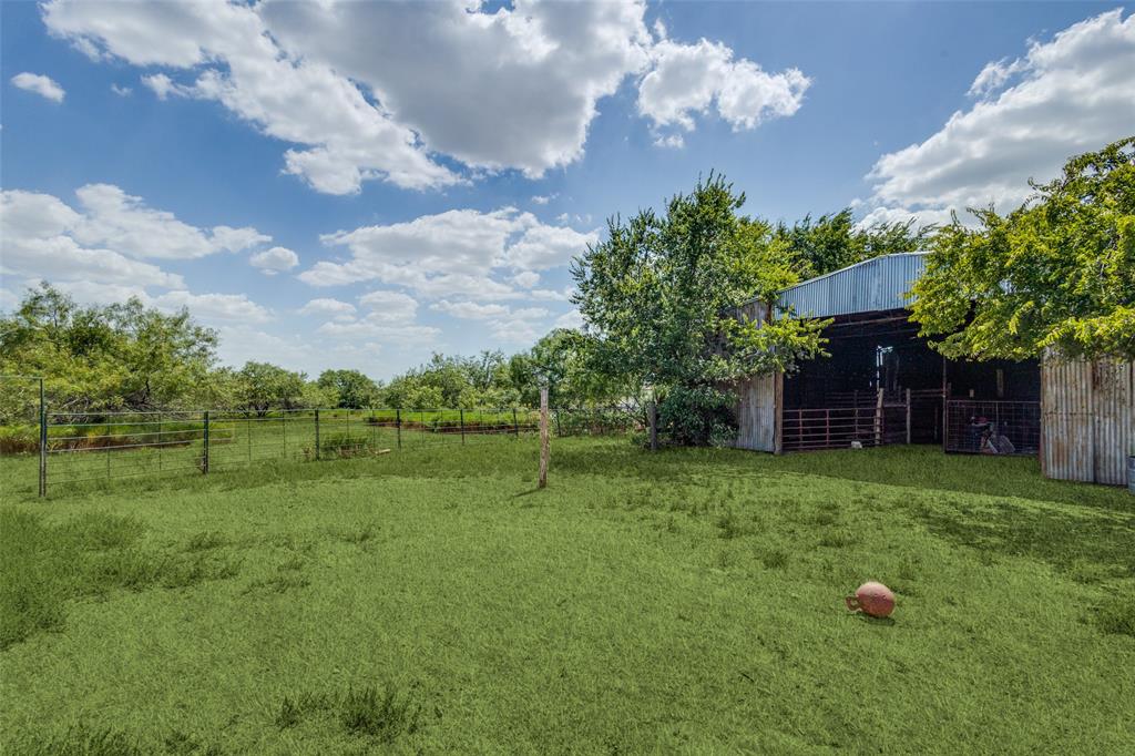 16777 John Wiley Road Justin, TX 76247 - Photo 8 of 16 a backyard of a house with lots of green space
