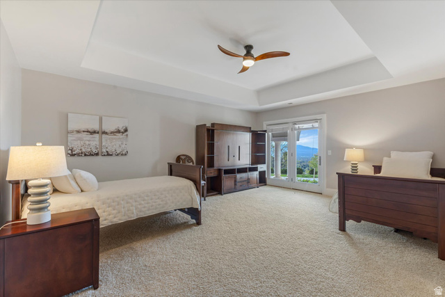 3222 Eagle View Circle Sandy, UT 84092 - Photo 36 of 60 Bedroom with access to exterior, light carpet, ceiling fan, and a tray ceiling
