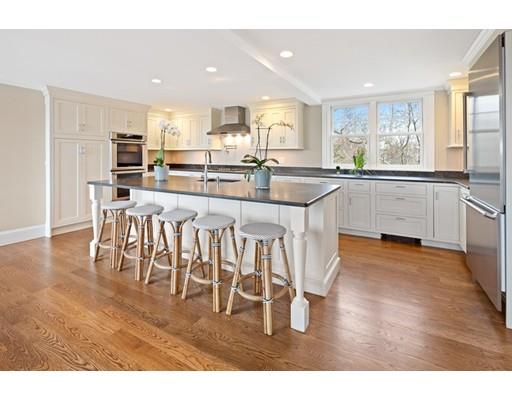 62 White Head Road Cohasset, MA 02025 - Photo 13 of 30 a open kitchen with stainless steel appliances granite countertop a stove top oven a sink and white cabinets with wooden floor