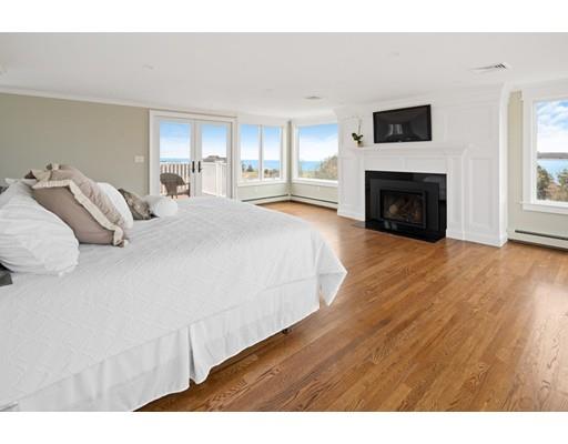 62 White Head Road Cohasset, MA 02025 - Photo 18 of 30 a spacious bedroom with a bed and a fireplace