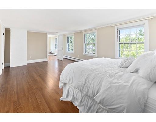 62 White Head Road Cohasset, MA 02025 - Photo 22 of 30 a spacious bedroom with a bed and wooden floor