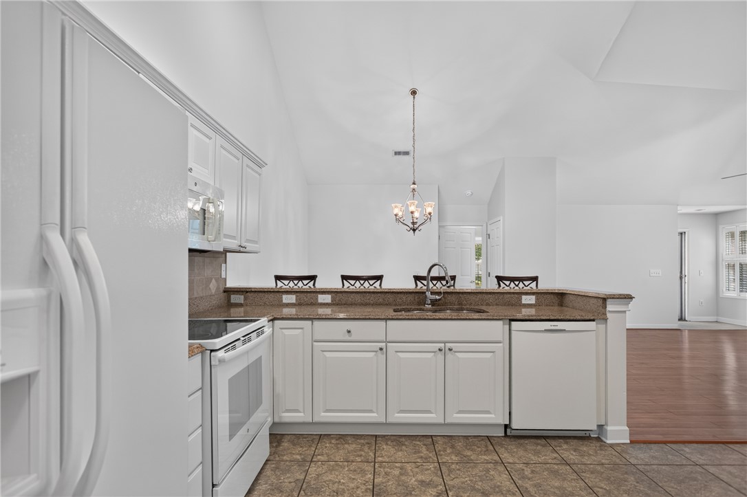 134 Life Style Lane Anderson, SC 29621 - Photo 3 of 44 A pristine culinary space with white cabinetry and practical appliances awaits your gourmet touch.