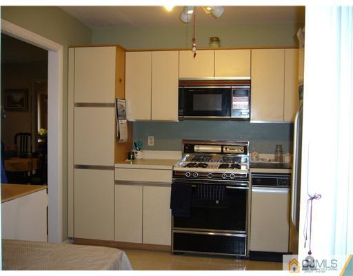 116 Heather Court Edison, NJ 08820 - Photo 6 of 9 a kitchen with stainless steel appliances granite countertop a stove a refrigerator and a microwave