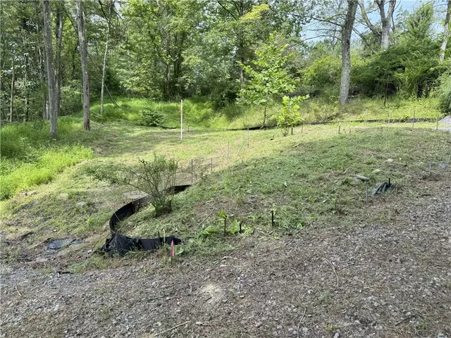 a backyard of a house with barbeque oven table and chairs