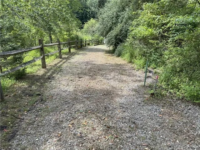 a backyard of a house with a yard and outdoor seating