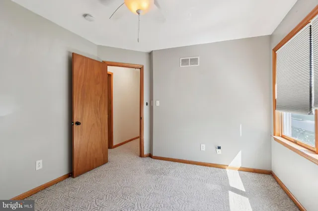 a view of an empty room with a window