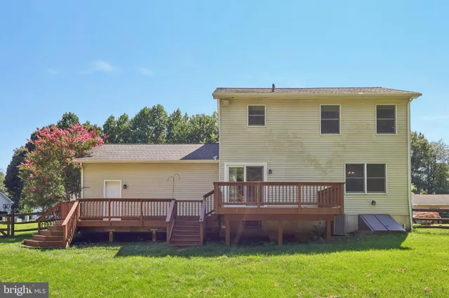 a view of a house with a yard and sitting area