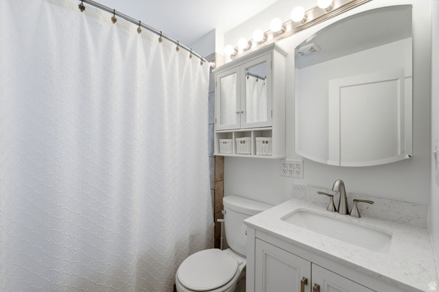1925 South Main Street Bountiful, UT 84010 - Photo 18 of 48 Bathroom featuring a white vanity with a light-colored countertop, an undermount sink, and brushed nickel fixtures