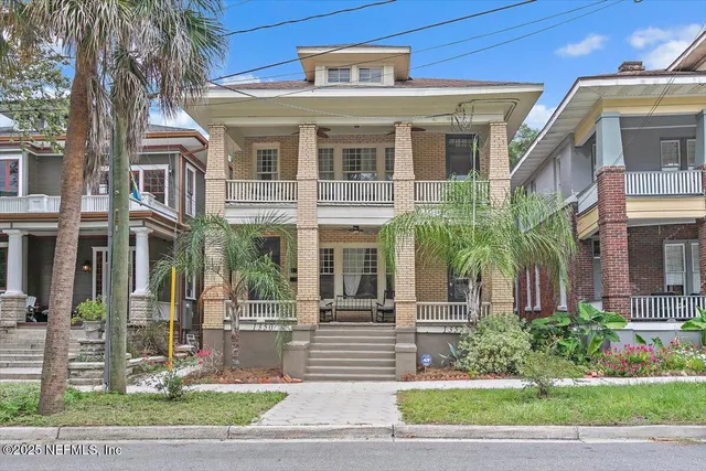 a front view of a residential apartment building with a yard