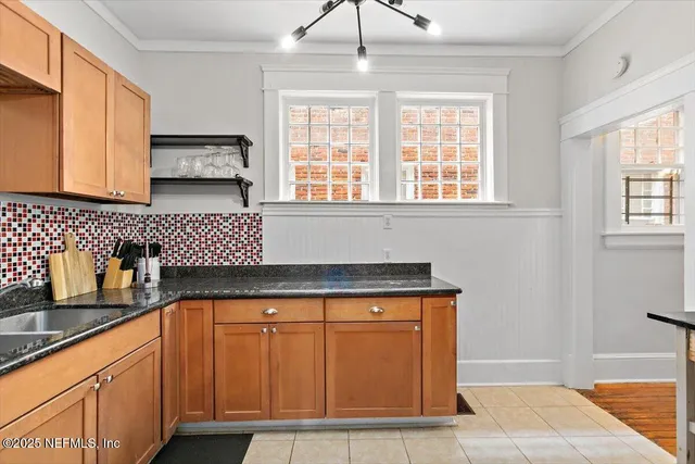 a kitchen with granite countertop a sink and a window