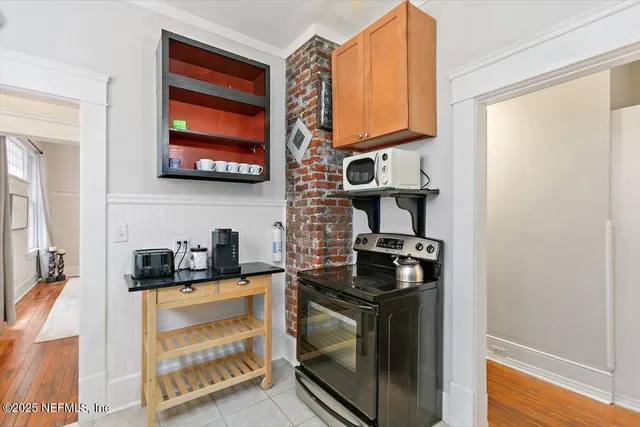 a kitchen with stainless steel appliances granite countertop a stove and a microwave