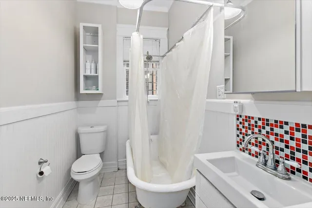 a white toilet sitting next to a bathroom sink