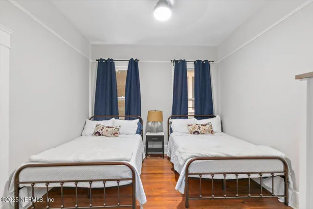 a bedroom with furniture and large window