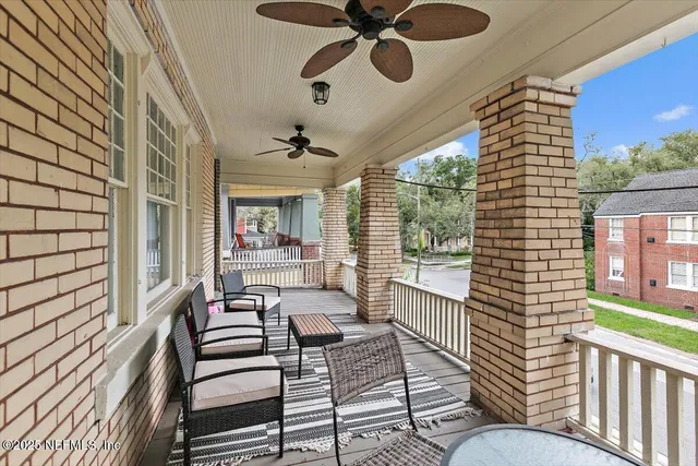 a balcony with furniture and a large window