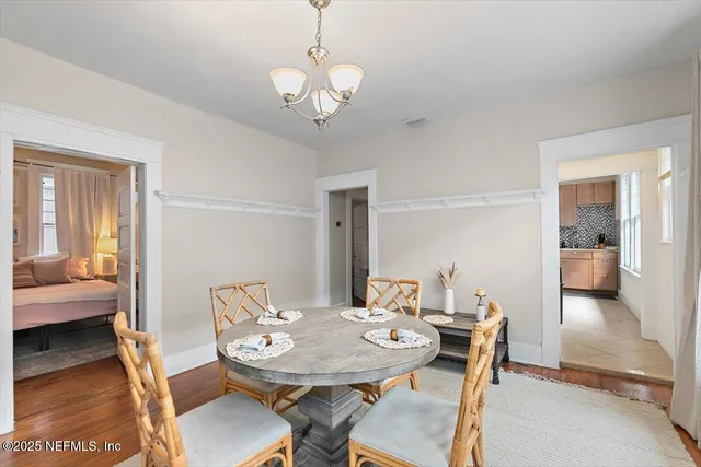 a view of a dining room with furniture wooden floor and a chandelier