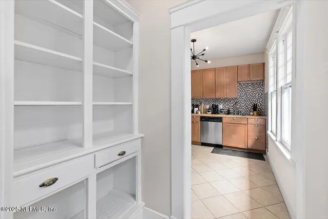 a kitchen with white cabinets and white appliances