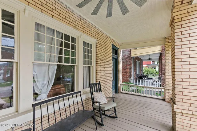 a view of a balcony with chair and wooden floor